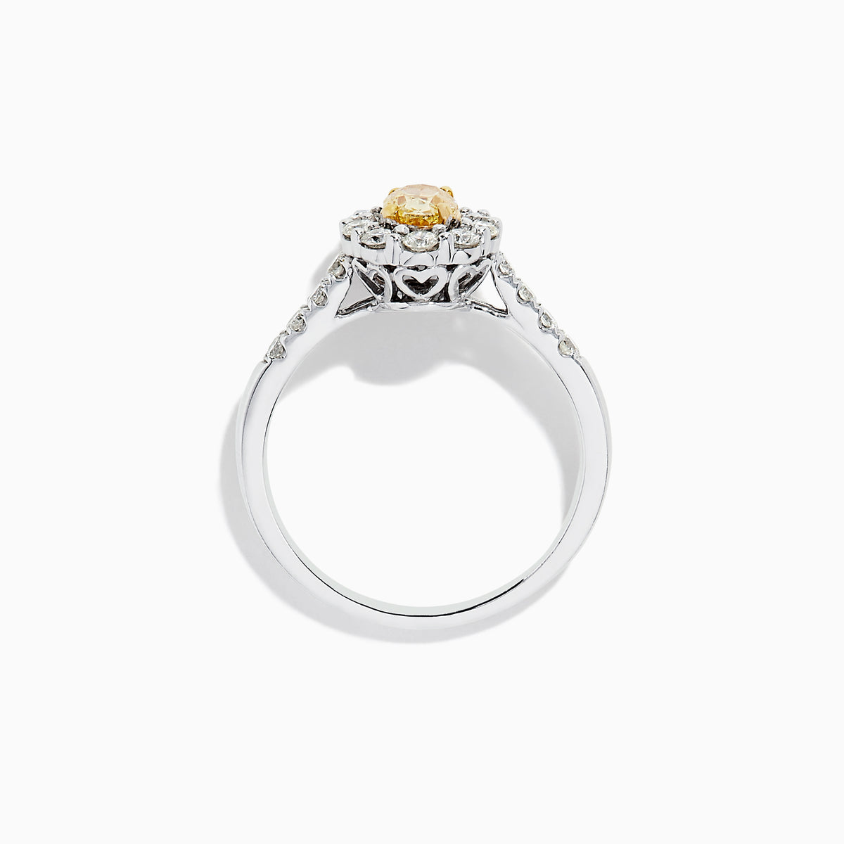 The 14K White Gold White and Fancy Yellow Diamond Ring, 1.10 TCW, features an oval yellow diamond center, haloed by clear round diamonds with more diamonds along the band—a timelessly elegant piece.