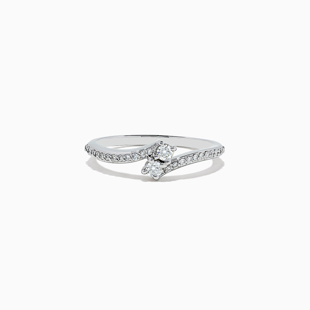 The 14k White Gold Diamond ring, 0.24 TCW, features a central round diamond on a curved band with sparkling accents and is displayed against a plain white background.
