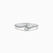 The 14k White Gold Diamond ring, 0.24 TCW, features a central round diamond on a curved band with sparkling accents and is displayed against a plain white background.