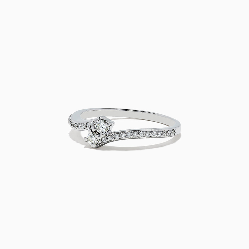The 14k White Gold Diamond ring, 0.24 TCW, features a central round diamond on a curved band with sparkling accents and is displayed against a plain white background.