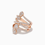 The 14K Rose Gold Diamond Crossover Ring features four overlapping diamond-encrusted bands adorned with three heart-shaped diamond clusters, elegantly spaced for a stunning look.