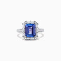 The Nahla Siri 14K White Gold Tanzanite and Diamond Ring, 5.03 TCW, features a large rectangular blue tanzanite center stone surrounded by a halo of baguette and round diamonds in an elegant, intricate design.