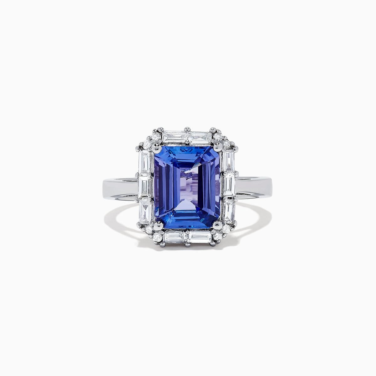 The Nahla Siri 14K White Gold Tanzanite and Diamond Ring, 5.03 TCW, features a large rectangular blue tanzanite center stone surrounded by a halo of baguette and round diamonds in an elegant, intricate design.
