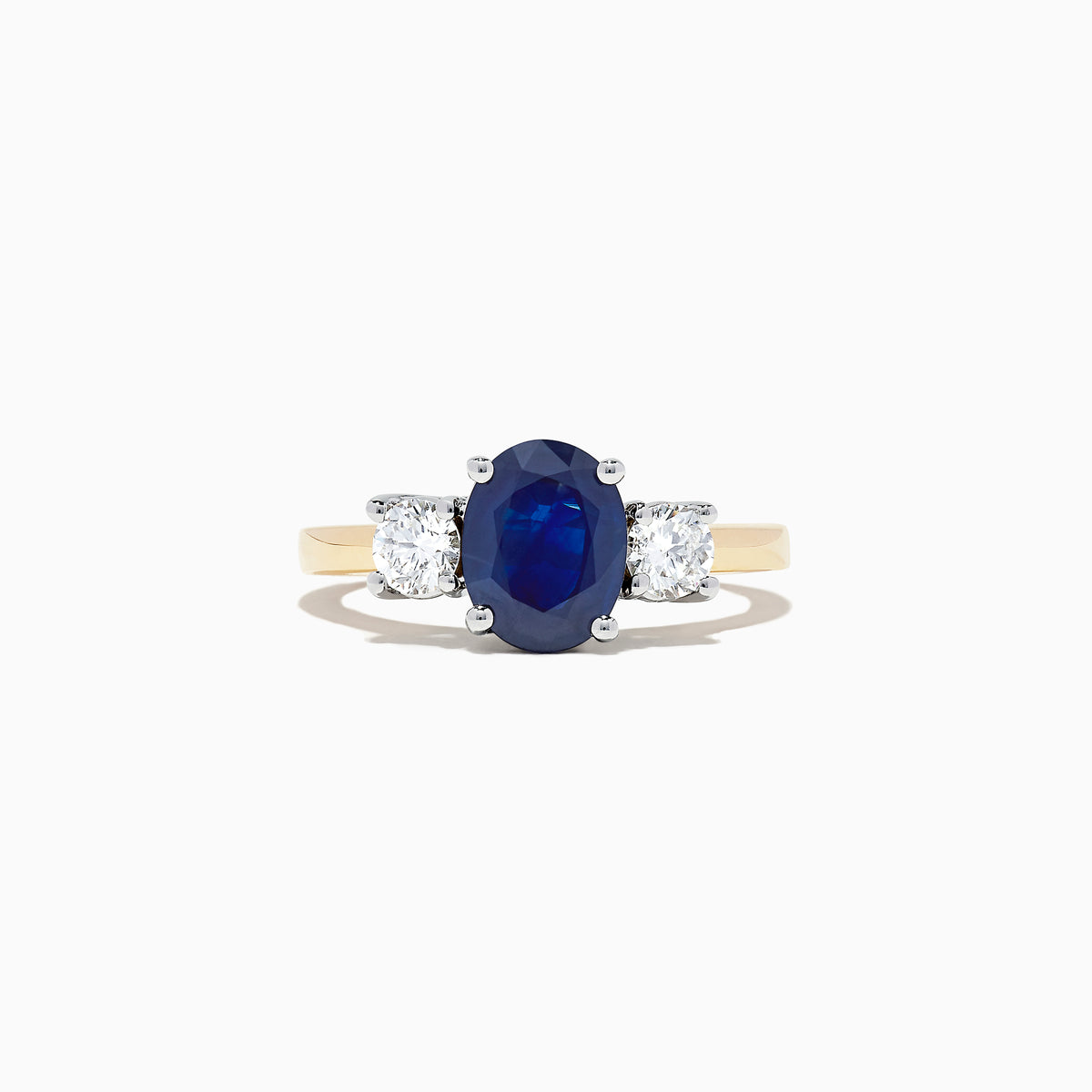 The Royale Bleu 14K Two Tone Gold Sapphire and Diamond Ring, 2.39 TCW, features an oval blue sapphire between two oval white diamonds, set in luxurious gold and shown on a white background.