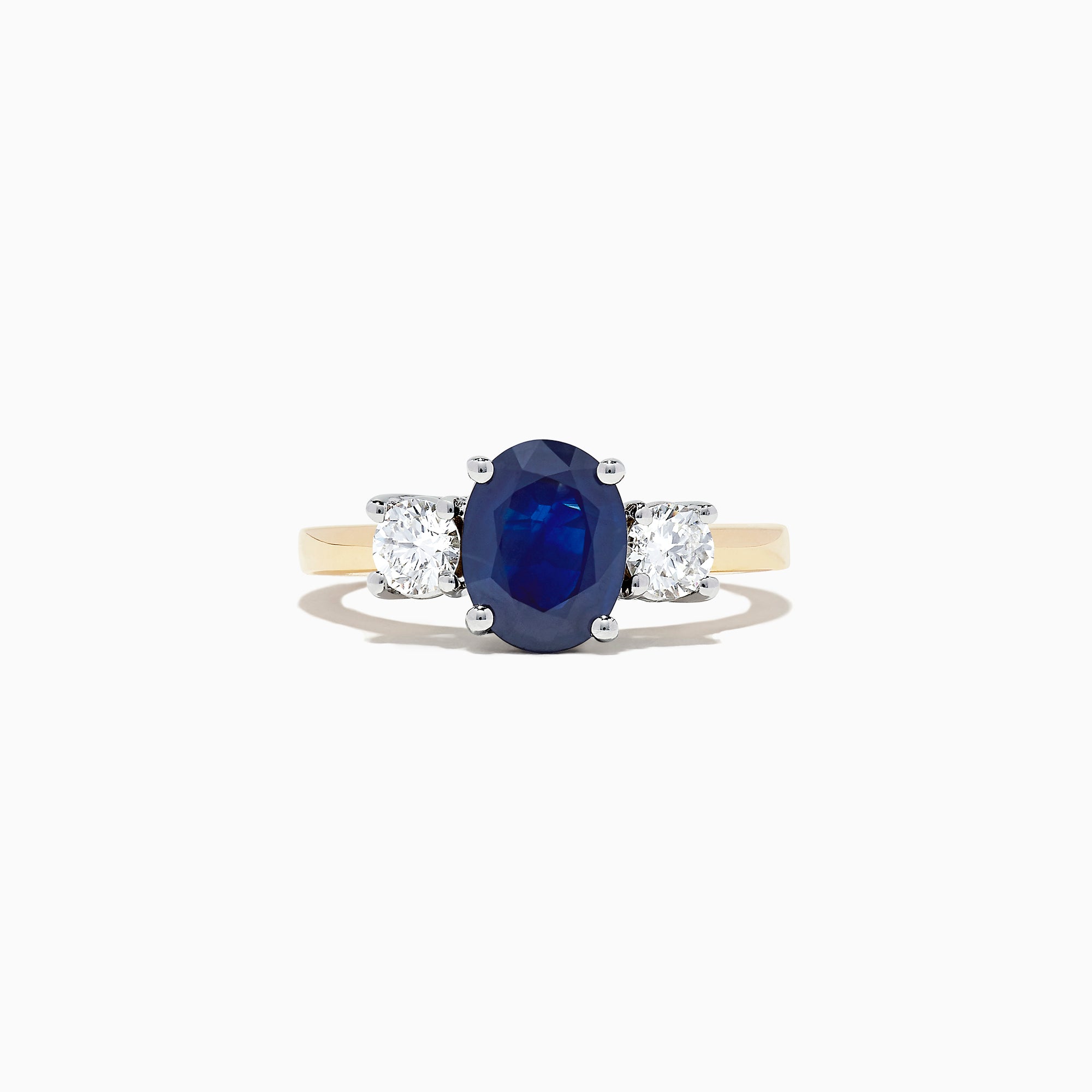 The Royale Bleu 14K Two Tone Gold Sapphire and Diamond Ring, 2.39 TCW, features an oval blue sapphire between two oval white diamonds, set in luxurious gold and shown on a white background.