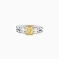 Experience elegance with the Canare 18K Gold Yellow Diamond Engagement & Wedding Ring Set, 2.57 TCW, showcasing a rectangular yellow diamond center and split gold band adorned with baguette clear stones on each side.