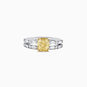 Experience elegance with the Canare 18K Gold Yellow Diamond Engagement & Wedding Ring Set, 2.57 TCW, showcasing a rectangular yellow diamond center and split gold band adorned with baguette clear stones on each side.