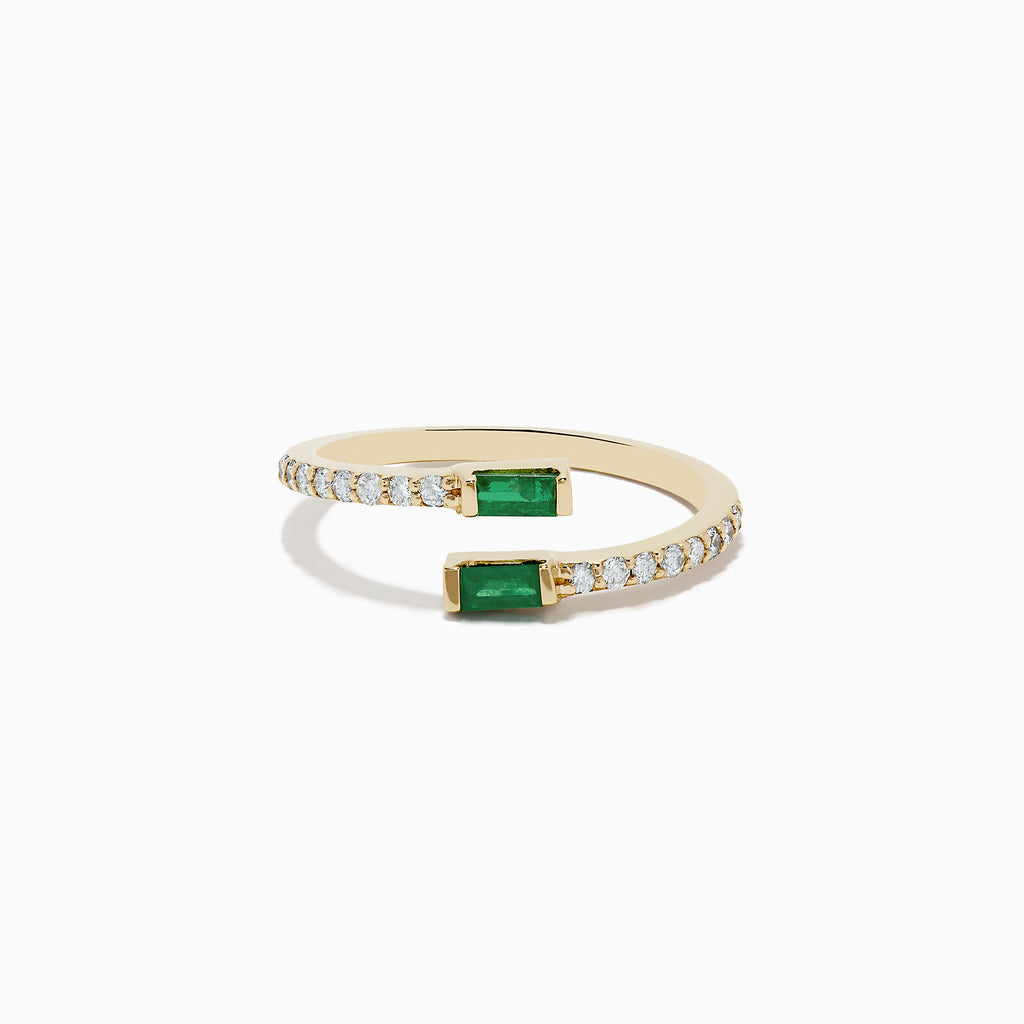 The 14K Yellow Gold Emerald and Diamond Bypass Ring features two rectangular emeralds at each open end, accented by small diamonds along part of the band.