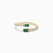 The 14K Yellow Gold Emerald and Diamond Bypass Ring features two rectangular emeralds at each open end, accented by small diamonds along part of the band.