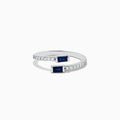 The Royale Bleu 14K White Gold Sapphire and Diamond Ring features two rectangular sapphires at each open end, accented with a row of sparkling diamonds along the band. The elegant design is displayed on a plain white background.