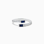 The Royale Bleu 14K White Gold Sapphire and Diamond Ring features two rectangular sapphires at each open end, accented with a row of sparkling diamonds along the band. The elegant design is displayed on a plain white background.