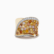 The 14K Yellow Gold Multi Color Diamond Statement Ring features a wavy design, yellow, orange, and pink gemstones, and is bordered by two rows of sparkling white multi color diamonds.