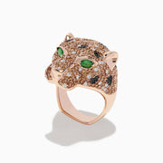 The 14K Rose Gold Emerald and Mixed Diamonds Panther Ring features a panther’s head design with brown and white diamonds, black gemstone spots, and two large emerald-green gemstones for eyes.
