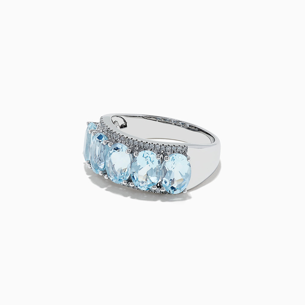 The 14k White Gold Aquamarine and Diamond ring, 3.90 TCW, showcases five oval aquamarine gems in a row with sparkling diamond accents, all set in white gold and displayed on a white background.