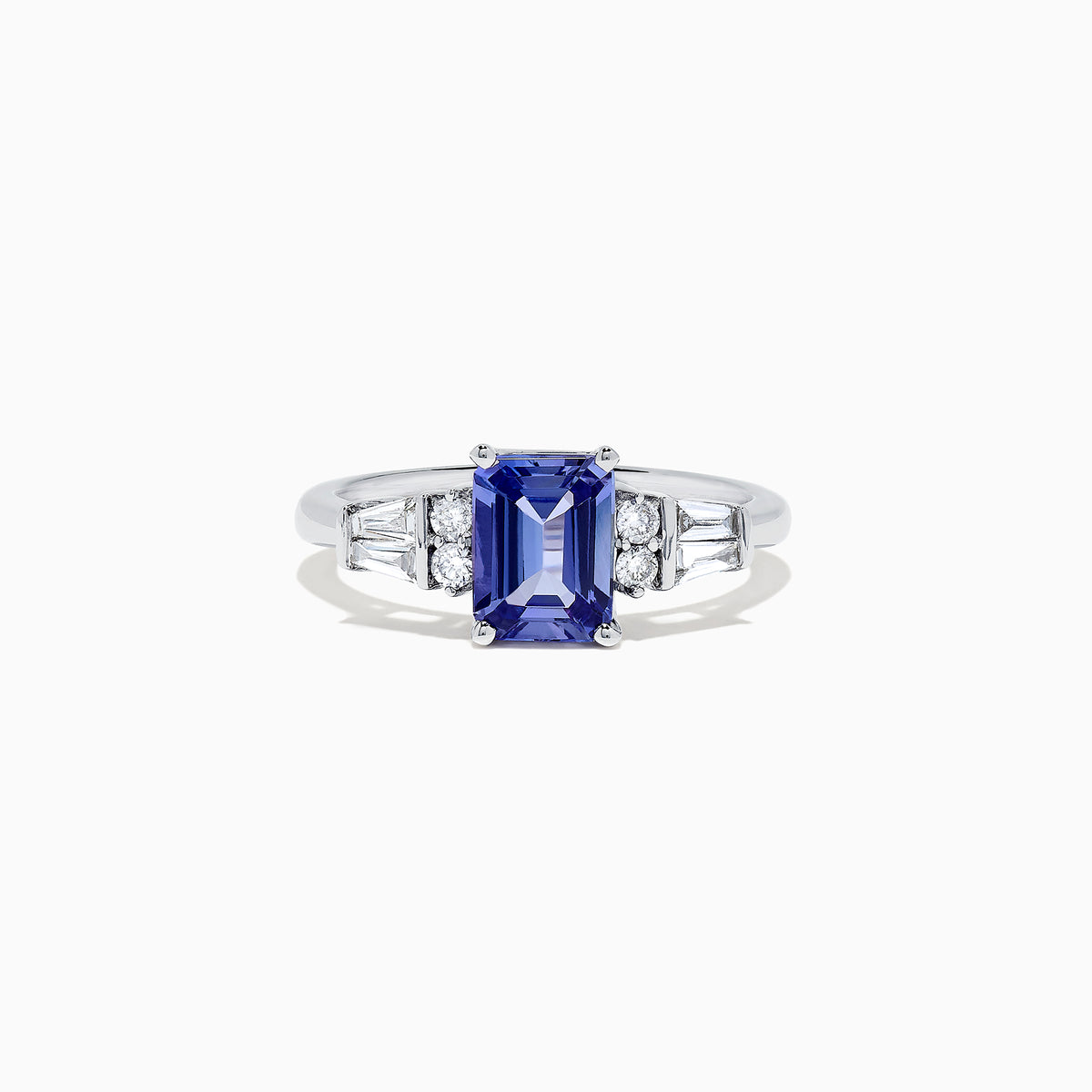 The Nahla Siri 14K White Gold Tanzanite and Diamond Ring, 1.51 TCW, features a rectangular tanzanite center stone accented by two small diamonds and tapered baguette diamonds on each side, set on a polished band.