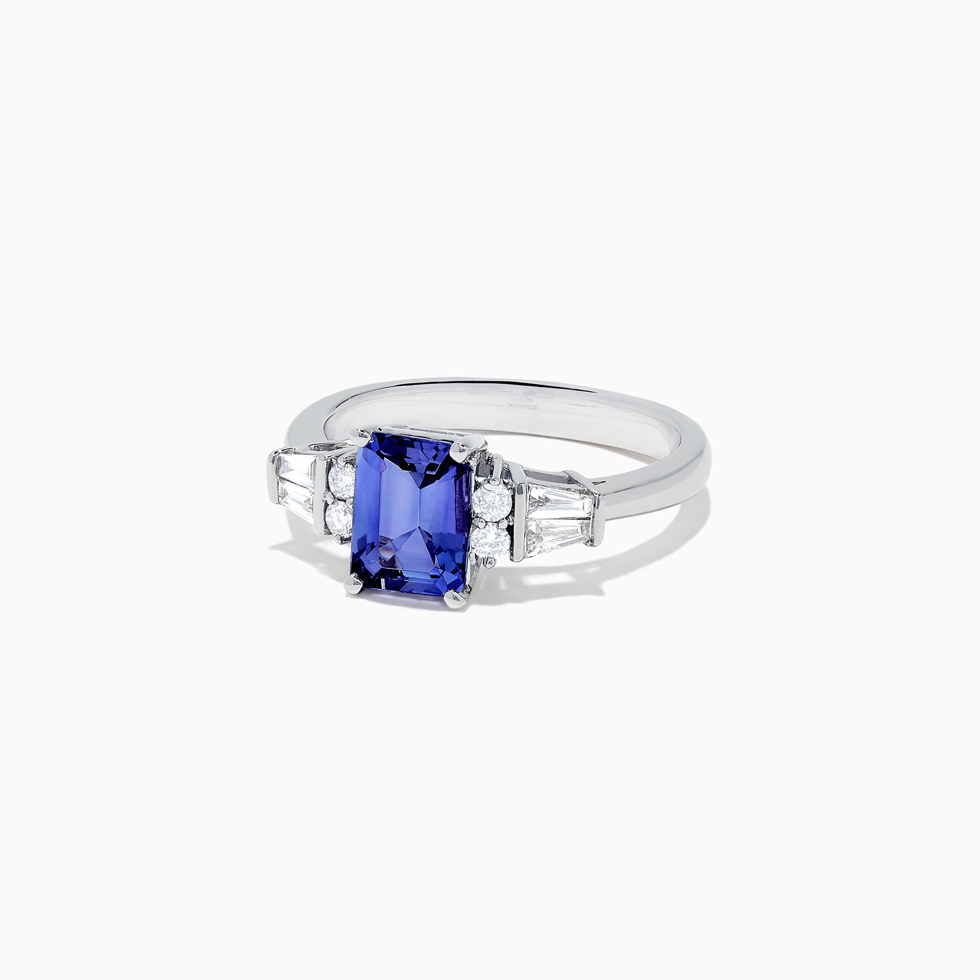 The Nahla Siri 14K White Gold Tanzanite and Diamond Ring, 1.51 TCW, features a rectangular tanzanite center stone accented by two small diamonds and tapered baguette diamonds on each side, set on a polished band.