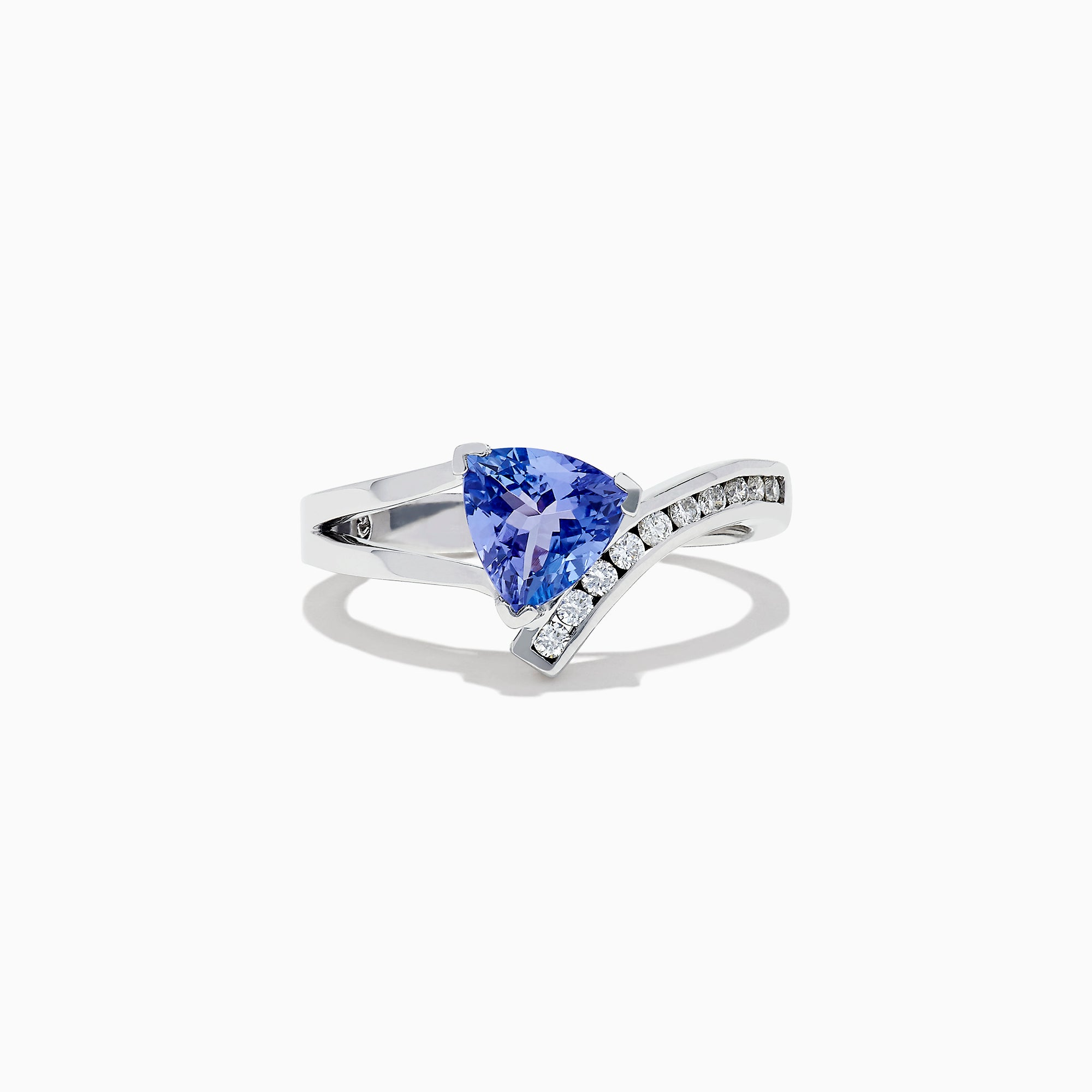 The Nahla Siri 14K White Gold Tanzanite and Diamond Ring (1.24 TCW) showcases a triangular blue tanzanite center, accented by a curved row of sparkling diamonds along the band.