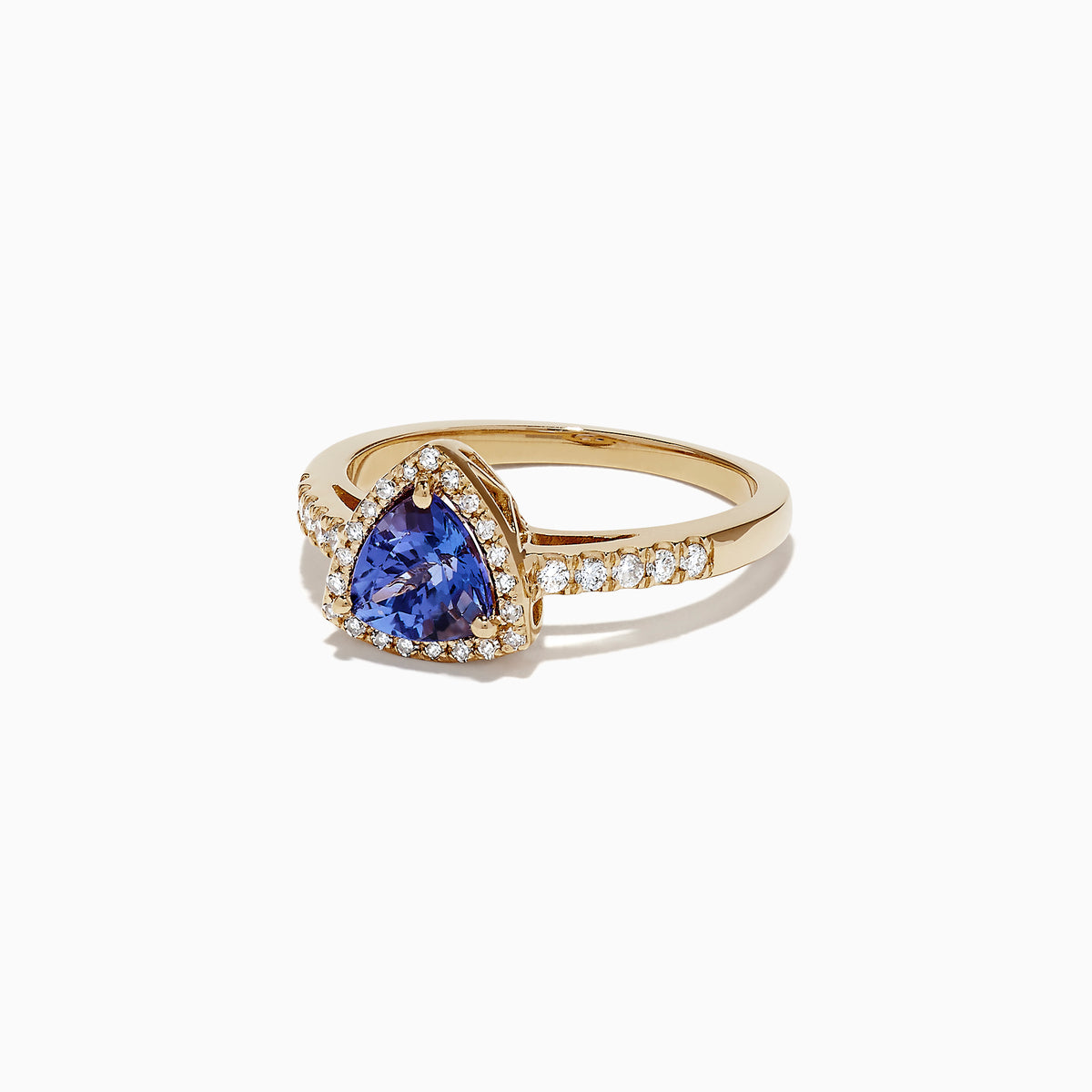 The Nahla Siri 14K Yellow Gold Tanzanite and Diamond Ring, 0.96 TCW, showcases a striking triangular tanzanite center framed by a halo of diamonds, with additional diamonds accenting the band for extra brilliance.