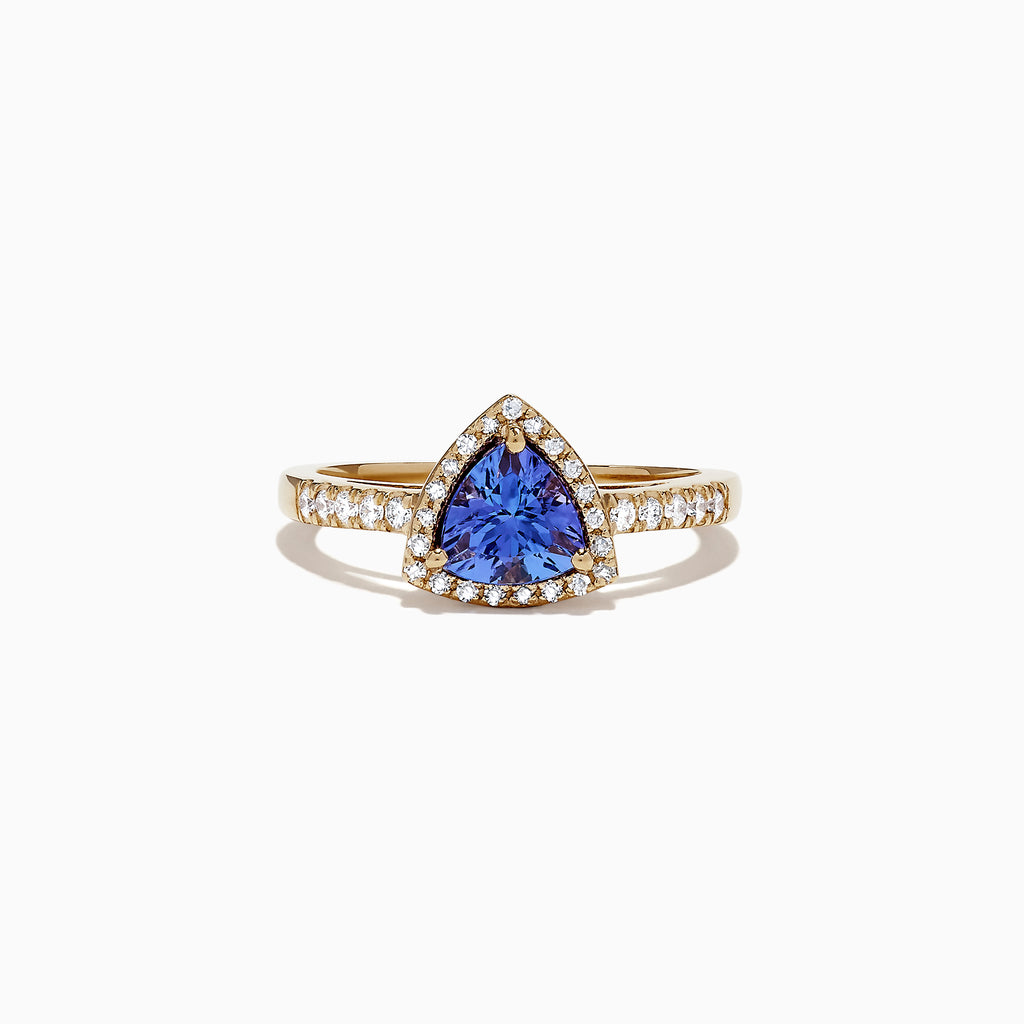 The Nahla Siri 14K Yellow Gold Tanzanite and Diamond Ring, 0.96 TCW, showcases a striking triangular tanzanite center framed by a halo of diamonds, with additional diamonds accenting the band for extra brilliance.