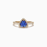 The Nahla Siri 14K Yellow Gold Tanzanite and Diamond Ring, 0.96 TCW, showcases a striking triangular tanzanite center framed by a halo of diamonds, with additional diamonds accenting the band for extra brilliance.