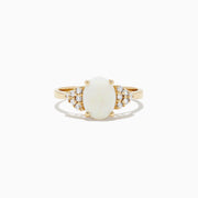 The 14K Yellow Gold Opal and Diamond Ring, 1.13 TCW features an oval white opal center accented by clusters of round diamonds on each side, all set in yellow gold against a white background.