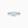 The Aquarius 14K White Gold Aquamarine and Diamond Ring, 1.09 TCW, showcases a round pale blue aquamarine center stone with sparkling diamonds along the band, presented on a white background.