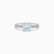 The Aquarius 14K White Gold Aquamarine and Diamond Ring, 1.09 TCW, showcases a round pale blue aquamarine center stone with sparkling diamonds along the band, presented on a white background.