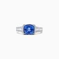 The Nahla Siri 14K White Gold Tanzanite and Diamond Ring, 2.18 TCW, features a cushion-cut blue tanzanite center accented by rows of sparkling diamonds on the band, shown against a white background.