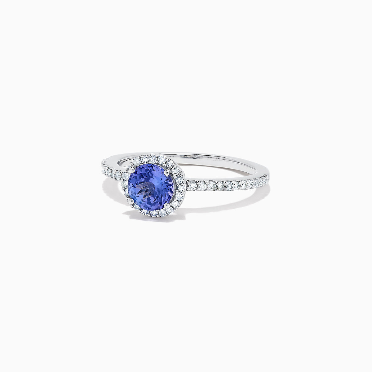 The Nahla Siri 14K White Gold Tanzanite and Diamond Ring, 1.08 TCW, features a round blue tanzanite encircled by a diamond halo with additional diamonds along the band for extra sparkle.