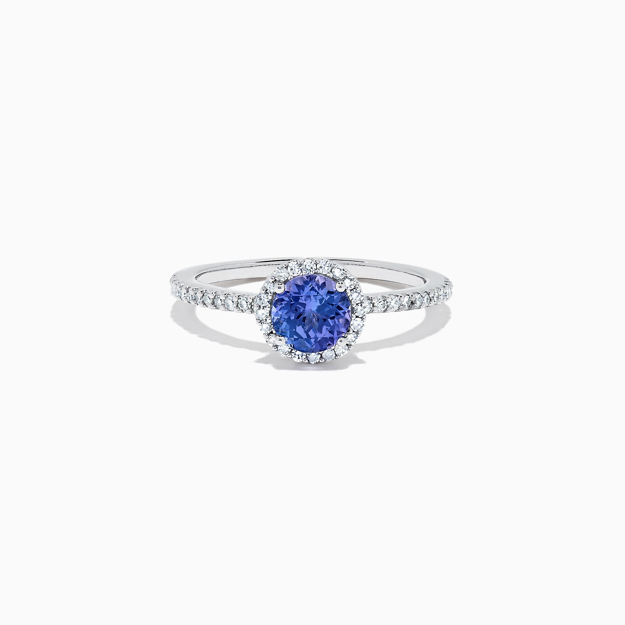 The Nahla Siri 14K White Gold Tanzanite and Diamond Ring, 1.08 TCW, features a round blue tanzanite encircled by a diamond halo with additional diamonds along the band for extra sparkle.
