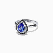 The Nahla Siri 14K White Gold Tanzanite and Diamond Ring, 1.43 TCW, features a pear-shaped blue tanzanite with a halo of white diamonds and diamond accents on the band, displayed on a white background.