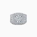The Bouquet 14K White Gold Diamond Ring features a large round center diamond surrounded by concentric rows of smaller diamonds, with the band also encrusted in sparkling diamonds.