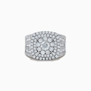 The Bouquet 14K White Gold Diamond Ring features a large round center diamond surrounded by concentric rows of smaller diamonds, with the band also encrusted in sparkling diamonds.