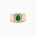 The Mens Brasillica 14K Yellow Gold Diamond and Emerald Ring features an oval green emerald center with a halo of round diamonds, displayed on a plain white background.