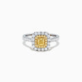 The Canare 18K Two Tone Gold Cushion Double Halo Yellow Diamond Ring, 0.97 TCW, features a square yellow diamond center with double white diamond halos and additional diamonds on the band.