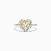 The Canare 14K Two Tone Gold Heart Shaped Yellow Diamond Heart Ring (0.77 TCW) features clustered yellow diamonds at the center, a halo of white diamonds, and a diamond-encrusted two tone gold band, shown on a white background.