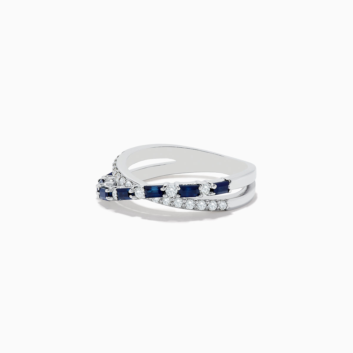 The Royale Bleu 14K White Gold Blue Sapphire and Diamond Crossover Ring features a wavy, crisscross design with alternating blue sapphires and round white diamonds on the bands, displayed on a plain white background.