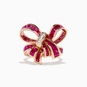 The Ruby Royale 14K Rose Gold Ruby Bow Ring, 3.70 TCW, features vibrant ruby-pink gemstones and a row of small rectangular white stones at the knot, elegantly set against a white background.