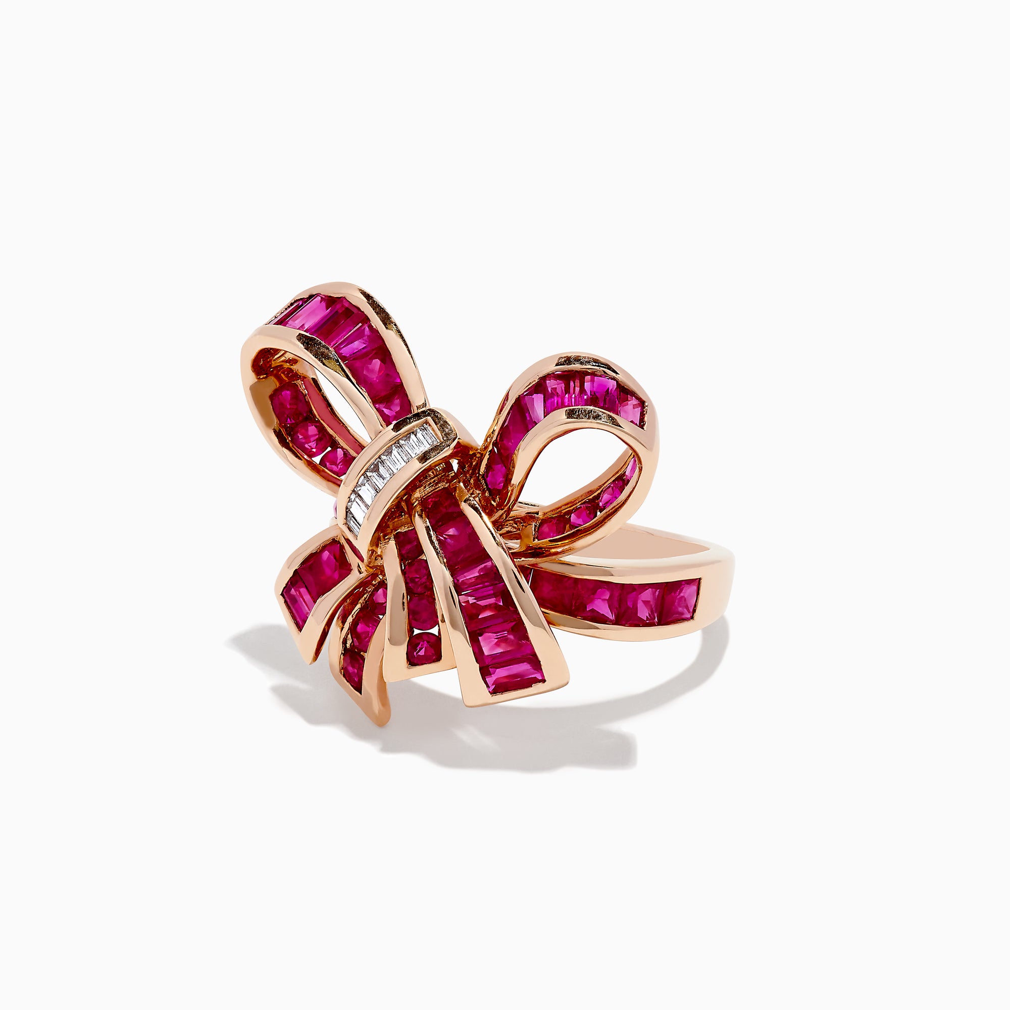 The Ruby Royale 14K Rose Gold Ruby Bow Ring, 3.70 TCW, features vibrant ruby-pink gemstones and a row of small rectangular white stones at the knot, elegantly set against a white background.