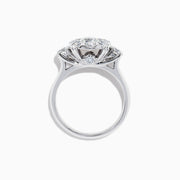 The Bouquet 14K White Gold Diamond Engagement Ring features a large round center diamond, a halo of sparkling stones, and diamonds along the band for added brilliance. Shown on a white background. Total carat weight: 1.91 TCW.