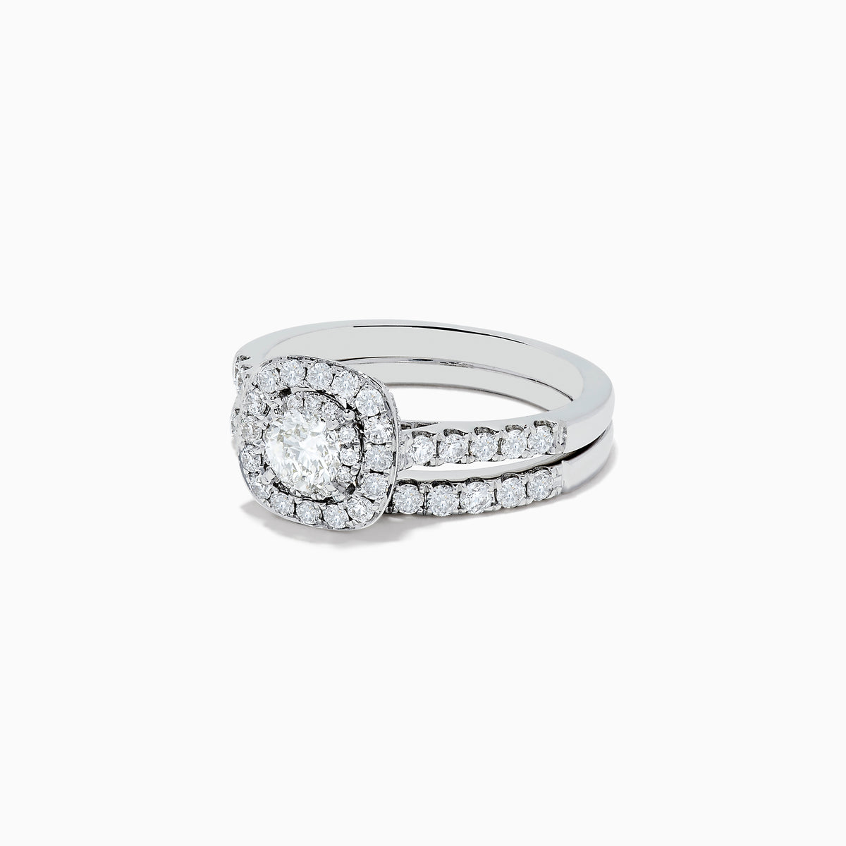 The Pave Classica 14K White Gold Diamond Engagement & Wedding Ring Set 1.34 TCW features a round center diamond, a sparkling diamond halo, and additional diamonds on the split band, shown against a white background.