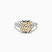 The Canare Two Tone Gold Cushion Shaped Cluster Yellow Diamond Ring 1.19 TCW features a vibrant yellow diamond cluster at the center, framed by white diamonds and accented with more diamonds along the band.