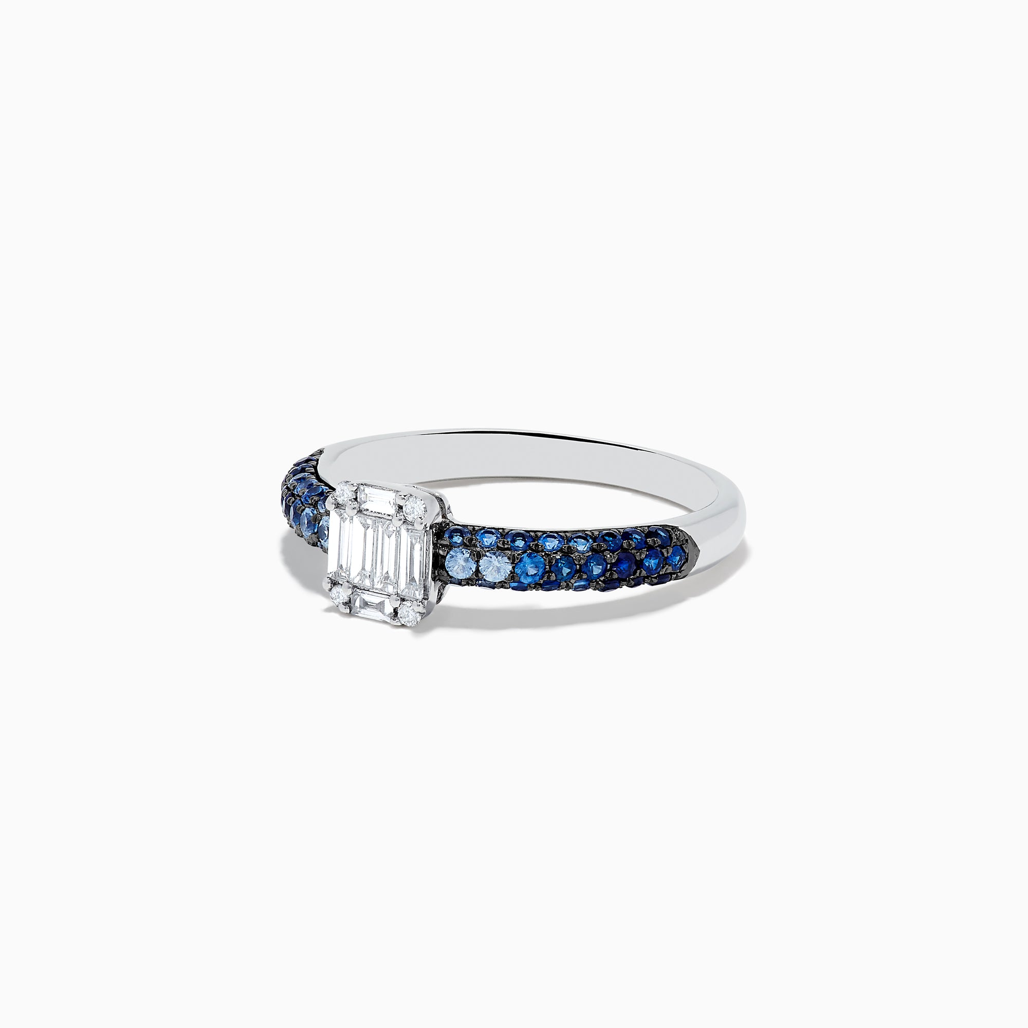 The Royale Bleu 14K White Gold Sapphire and Diamond Ring features a rectangular emerald-cut diamond centerpiece with round blue sapphires along the band, creating an elegant and symmetrical look. Shown photographed on a white background.