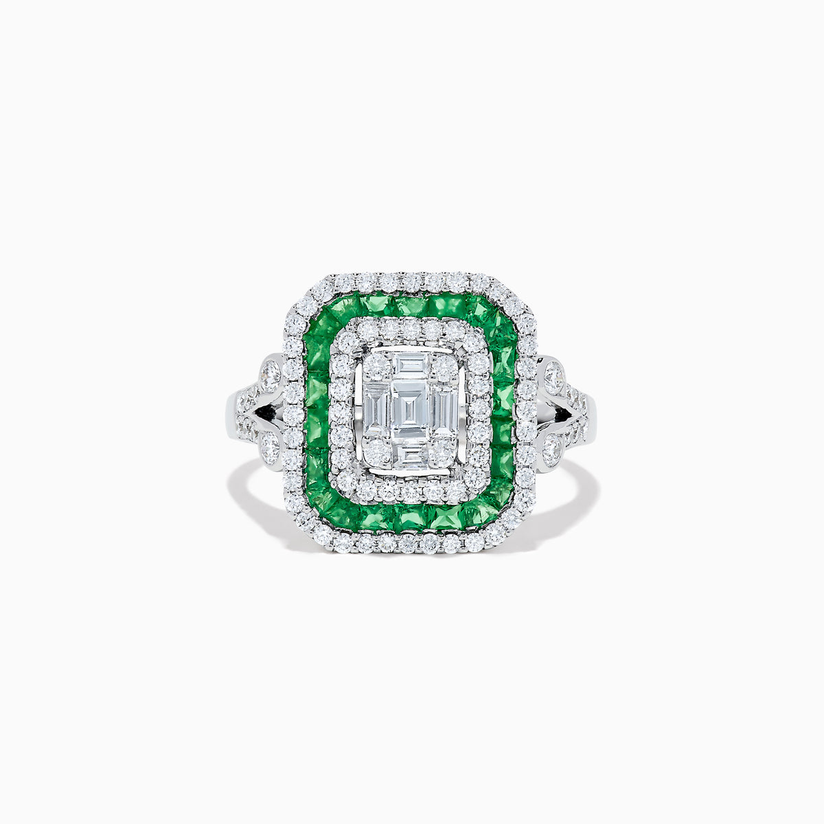 The Brasilica 14K White Gold Emerald and Diamond Ring showcases an emerald-cut diamond center, double square halos of diamonds and green emeralds, with additional diamonds on the split shank band, all set against a white background.