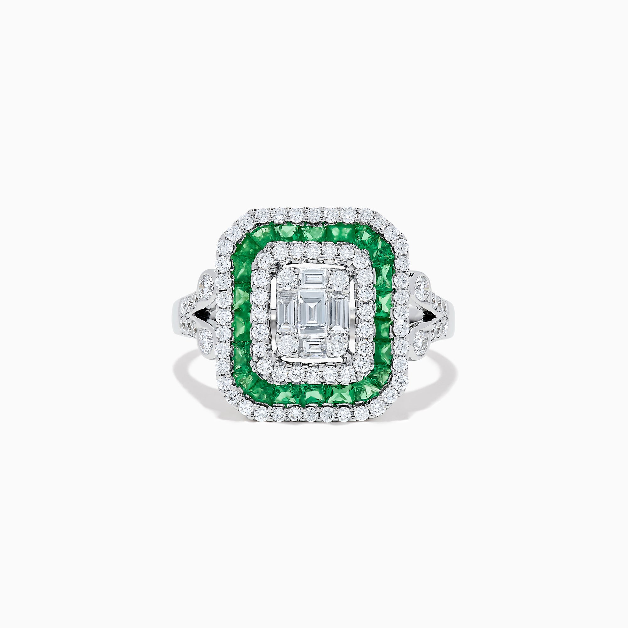 The Brasilica 14K White Gold Emerald and Diamond Ring showcases an emerald-cut diamond center, double square halos of diamonds and green emeralds, with additional diamonds on the split shank band, all set against a white background.