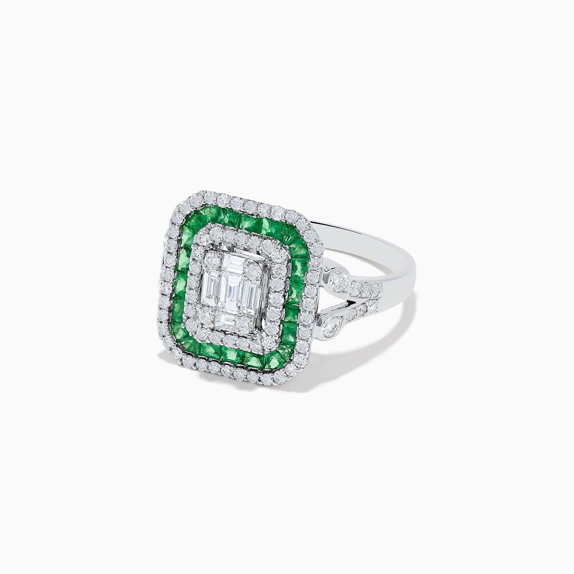 The Brasilica 14K White Gold Emerald and Diamond Ring showcases an emerald-cut diamond center, double square halos of diamonds and green emeralds, with additional diamonds on the split shank band, all set against a white background.