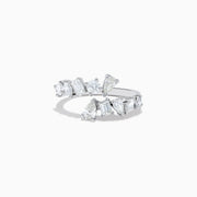 The Classique 14K White Gold Diamond Bypass Ring 1.36 TCW features multiple clear diamonds in teardrop, round, and rectangular cuts set asymmetrically on a sleek open band, styled against a plain white background.