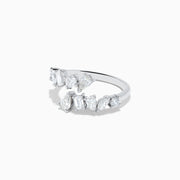 The Classique 14K White Gold Diamond Bypass Ring 1.36 TCW features multiple clear diamonds in teardrop, round, and rectangular cuts set asymmetrically on a sleek open band, styled against a plain white background.