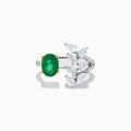 The Brasilica 14K White Gold Emerald and Diamond Ring showcases an oval green emerald in gold prongs on one side and pear-shaped white diamonds in a floral pattern on the other, all crafted in luxurious 14K white gold.