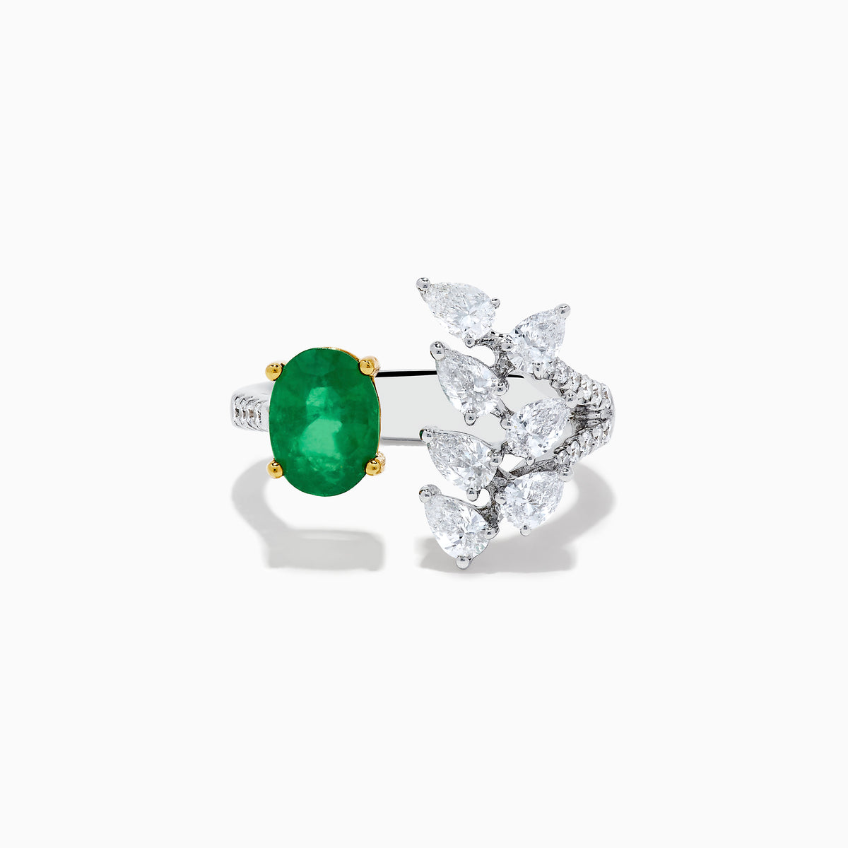 The Brasilica 14K White Gold Emerald and Diamond Ring showcases an oval green emerald in gold prongs on one side and pear-shaped white diamonds in a floral pattern on the other, all crafted in luxurious 14K white gold.